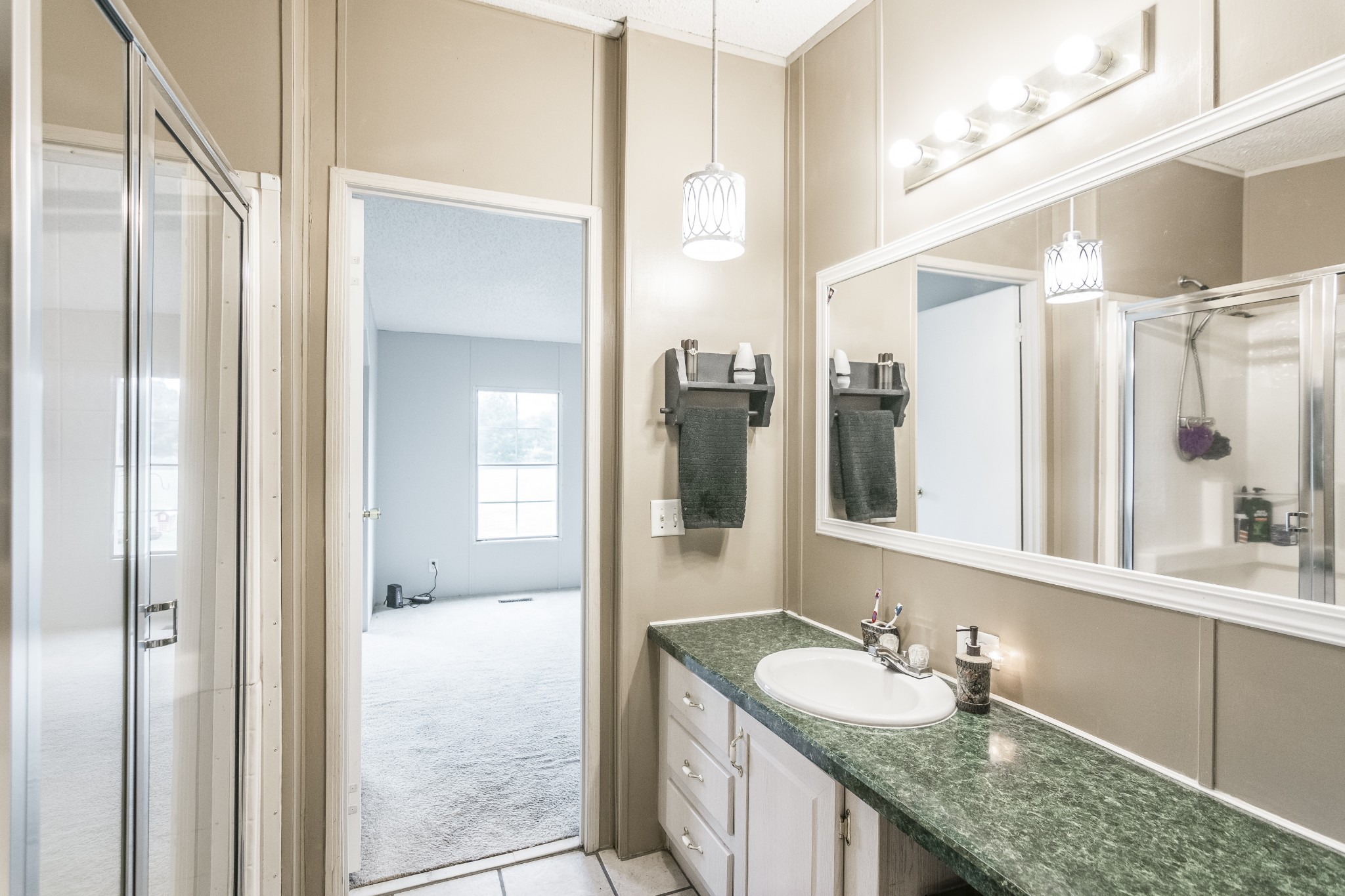 128 East Biggs Road Portland, TN 37148 - Photo 25 of 43 a bathroom with a granite countertop sink and a mirror