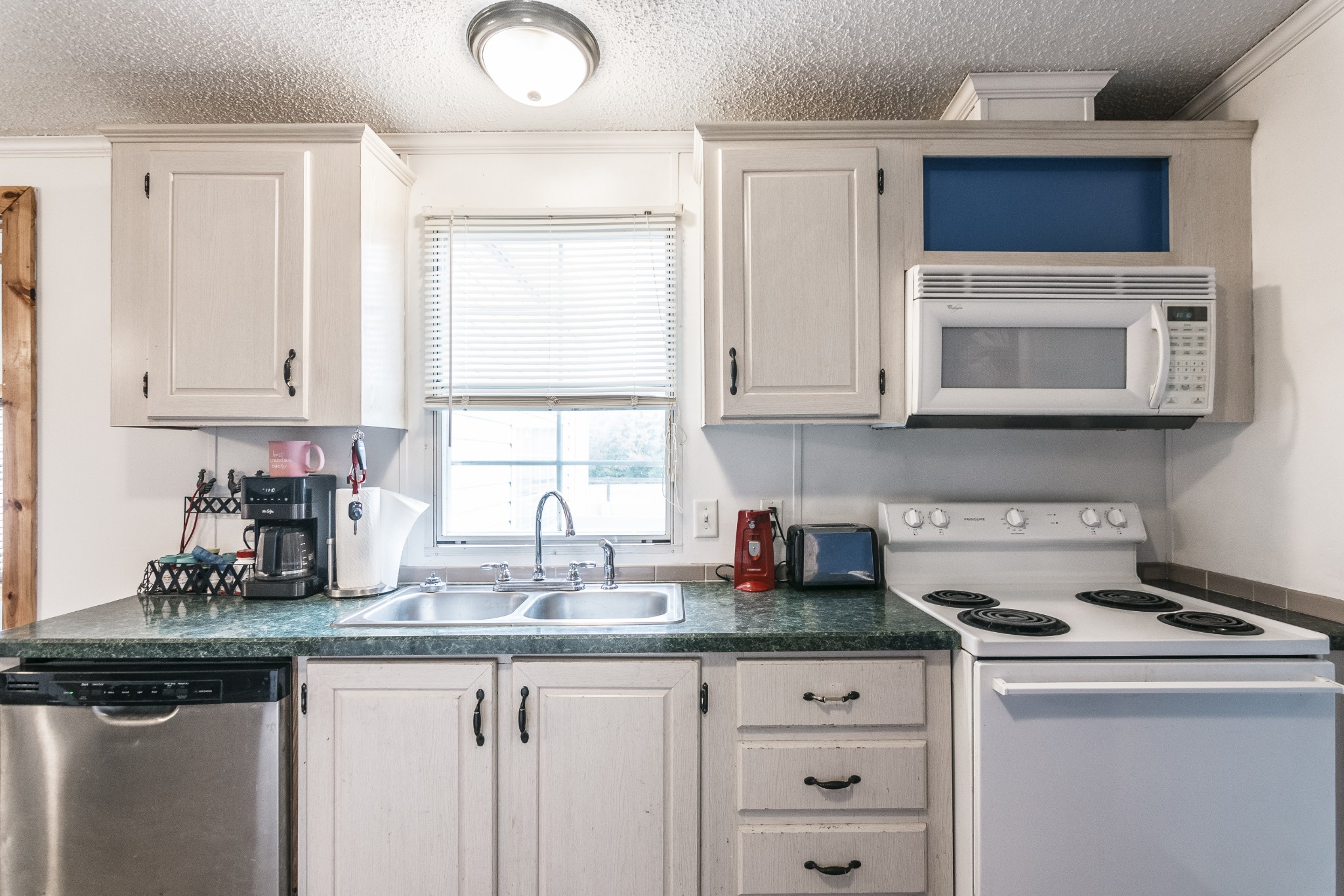 128 East Biggs Road Portland, TN 37148 - Photo 6 of 43 a kitchen with stainless steel appliances granite countertop a sink and a microwave