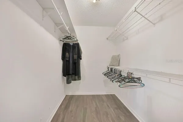 a view of an empty room with a window and a ceiling fan