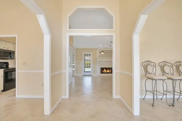 a view of a big room with windows and entryway