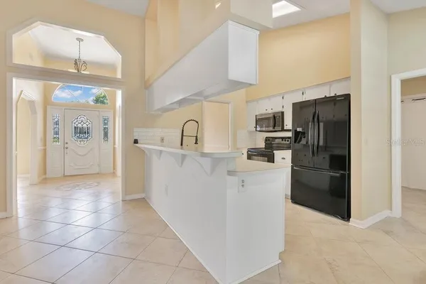a kitchen with cabinets and a stove
