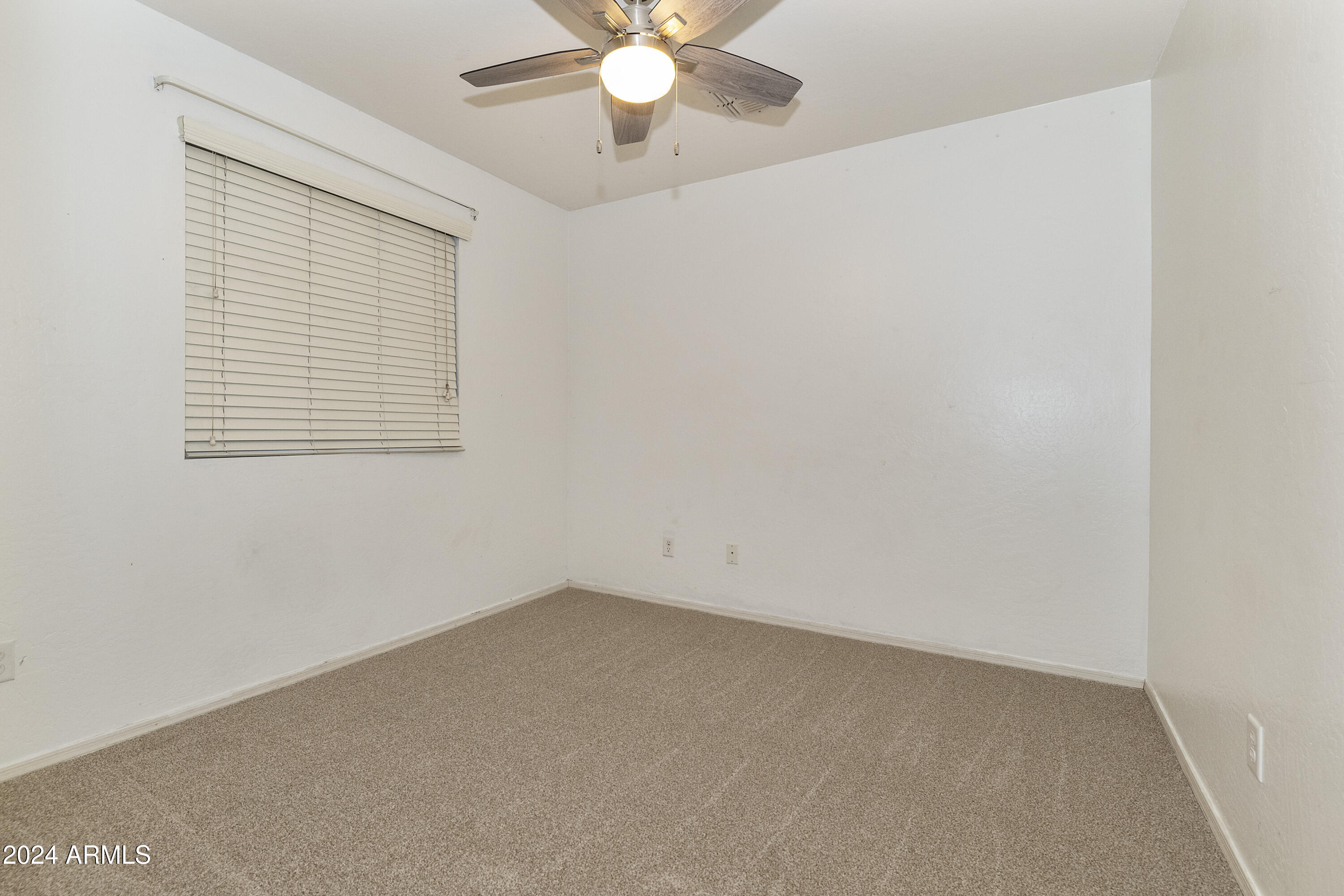 4232 East Tyson Street Gilbert, AZ 85295 - Photo 23 of 38 an empty room with a window and a fan