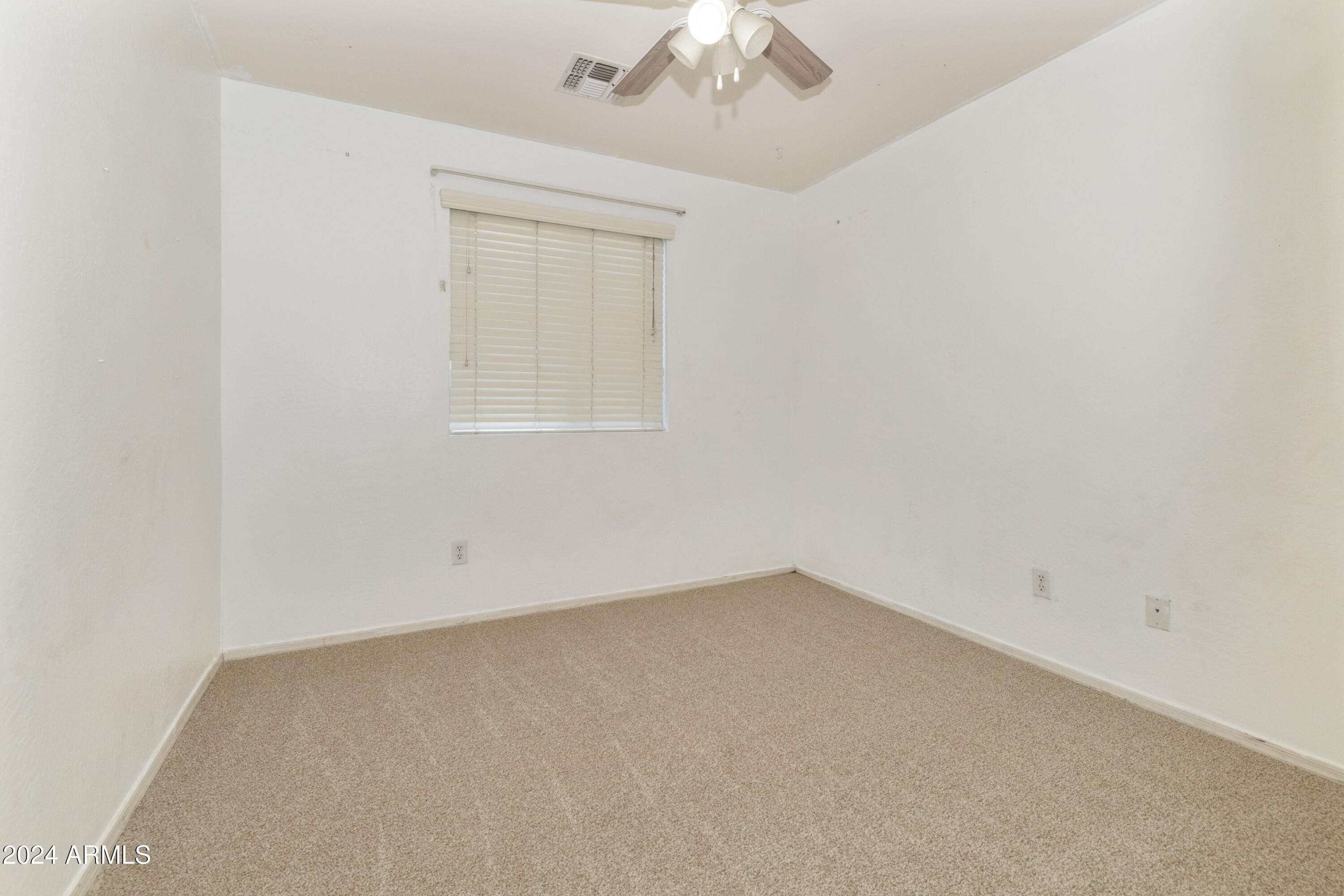 4232 East Tyson Street Gilbert, AZ 85295 - Photo 24 of 38 an empty room with a chandelier fan