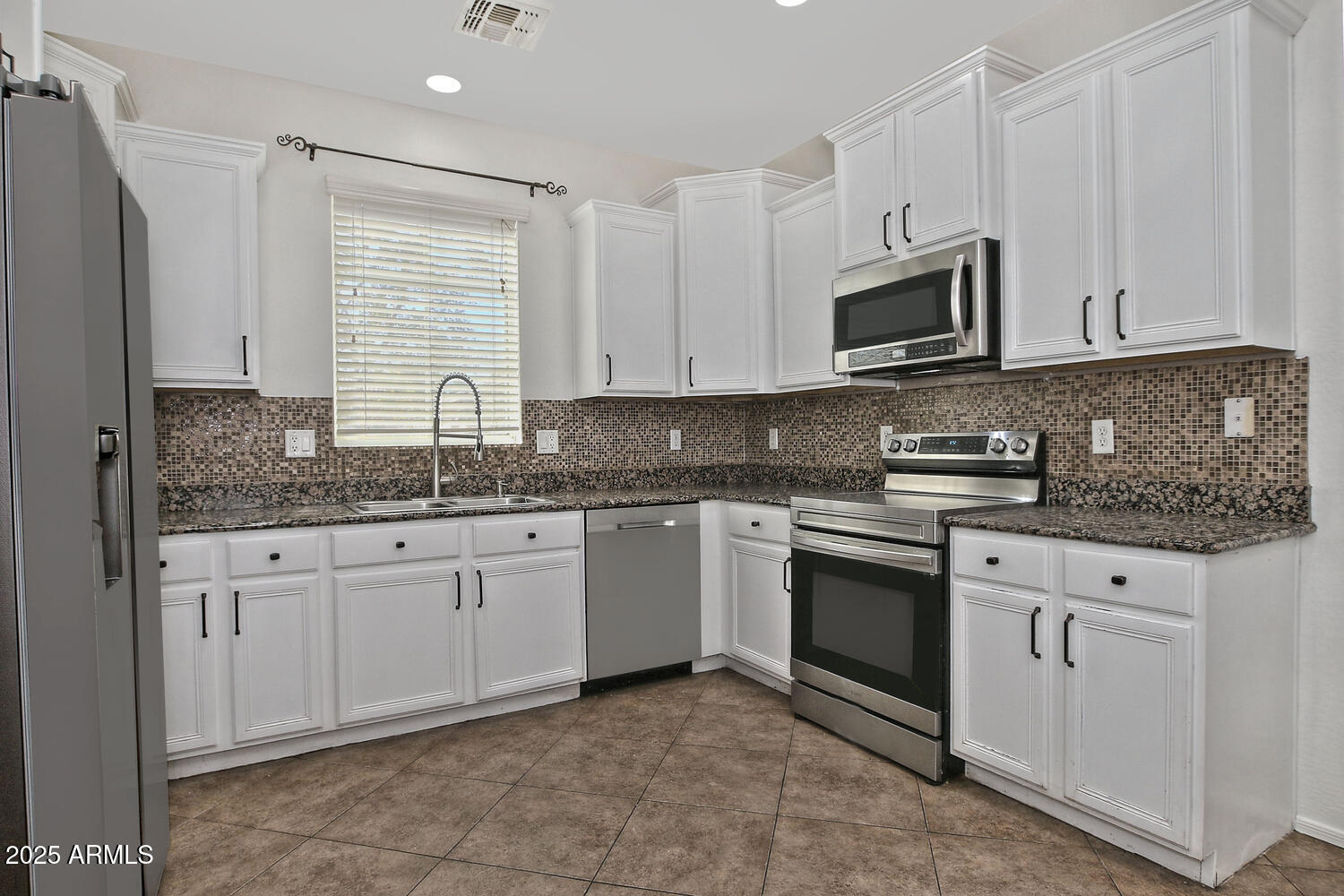 4232 East Tyson Street Gilbert, AZ 85295 - Photo 7 of 38 a kitchen with granite countertop white cabinets white stainless steel appliances with a sink and dishwasher