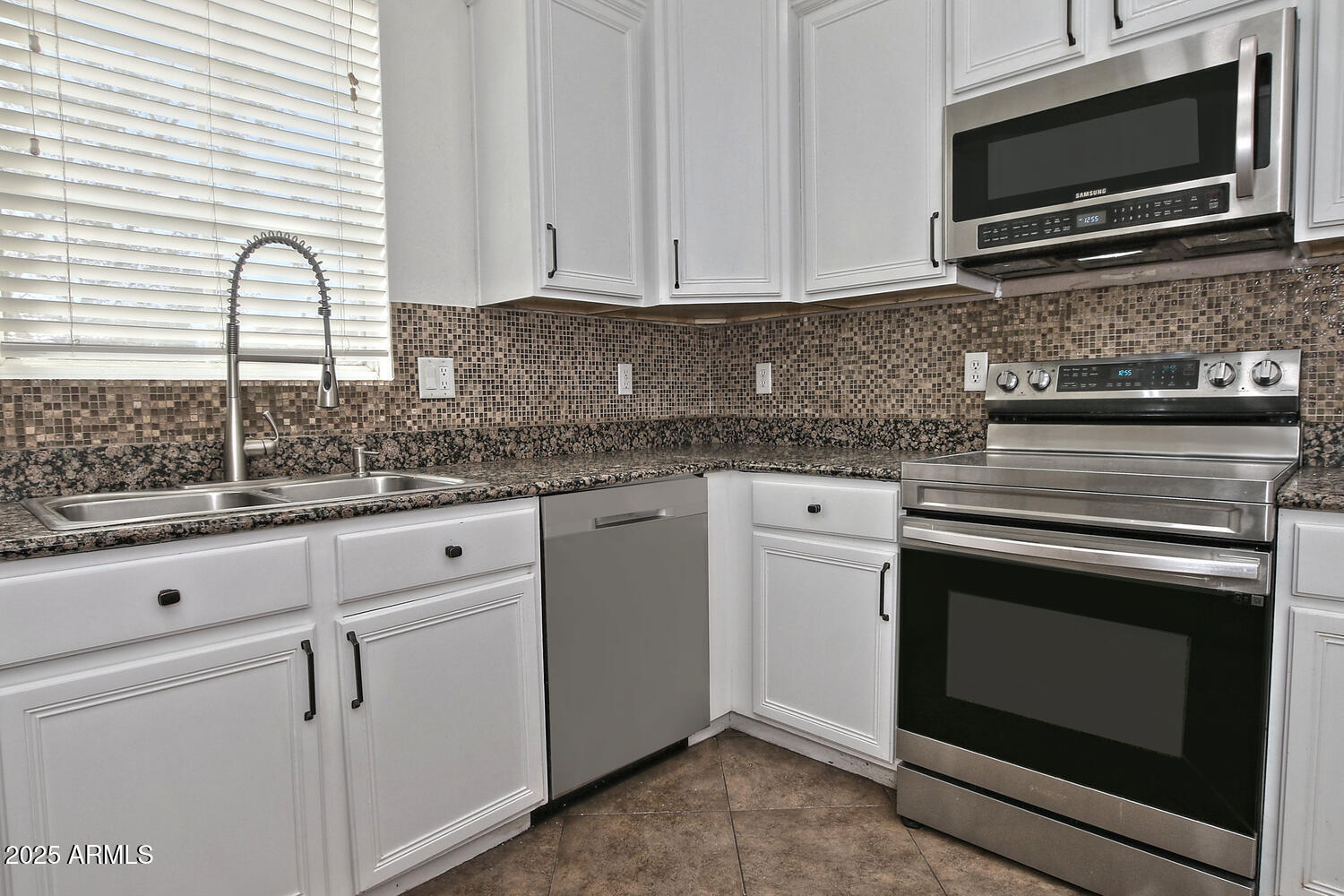 4232 East Tyson Street Gilbert, AZ 85295 - Photo 8 of 38 a kitchen with white cabinets stainless steel appliances and a sink