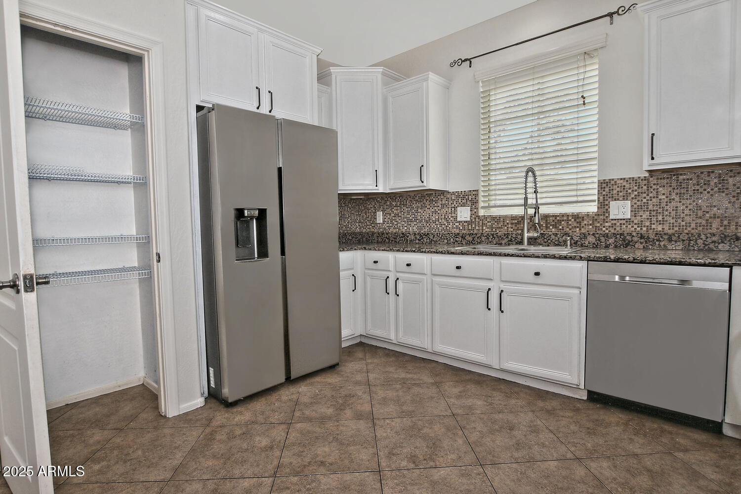 4232 East Tyson Street Gilbert, AZ 85295 - Photo 9 of 38 a kitchen with a sink a refrigerator and cabinets