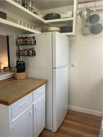 a kitchen with a refrigerator and a stove