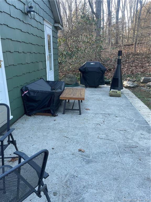 87 B Red Coat Road Westport, CT 06880 - Photo 16 of 17 a view of a backyard with furniture and a couch