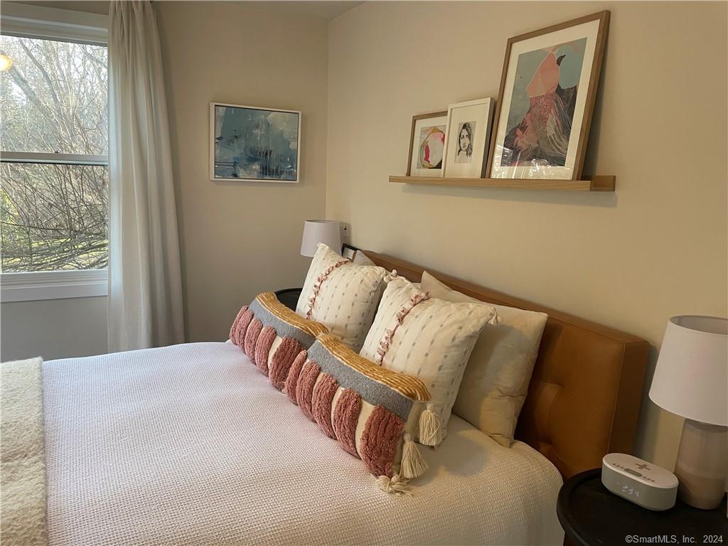 87 B Red Coat Road Westport, CT 06880 - Photo 7 of 17 a bedroom with a bed and a painting on the wall