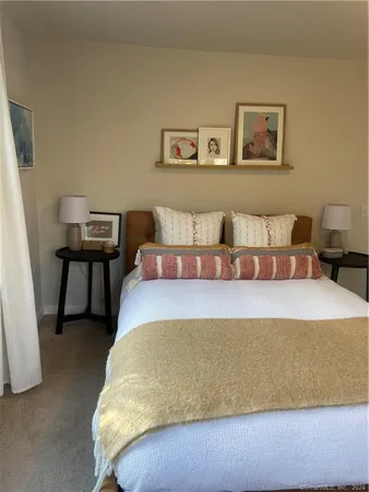 a bedroom with a bed and chair