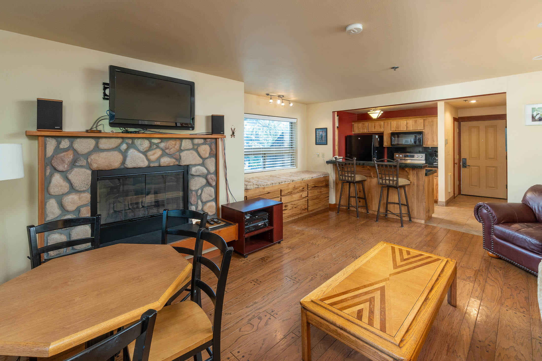 18575 Southwest Century Drive, Unit 2018 Bend, OR 97702 - Photo 3 of 32 a living room with furniture a flat screen tv and a fireplace