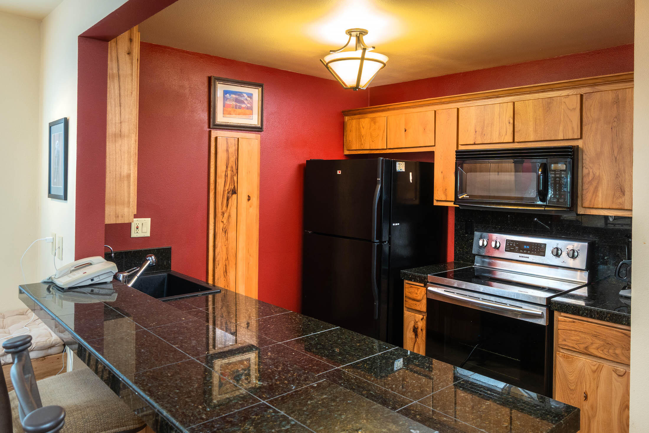 18575 Southwest Century Drive, Unit 2018 Bend, OR 97702 - Photo 4 of 32 a kitchen with stainless steel appliances a stove microwave and refrigerator