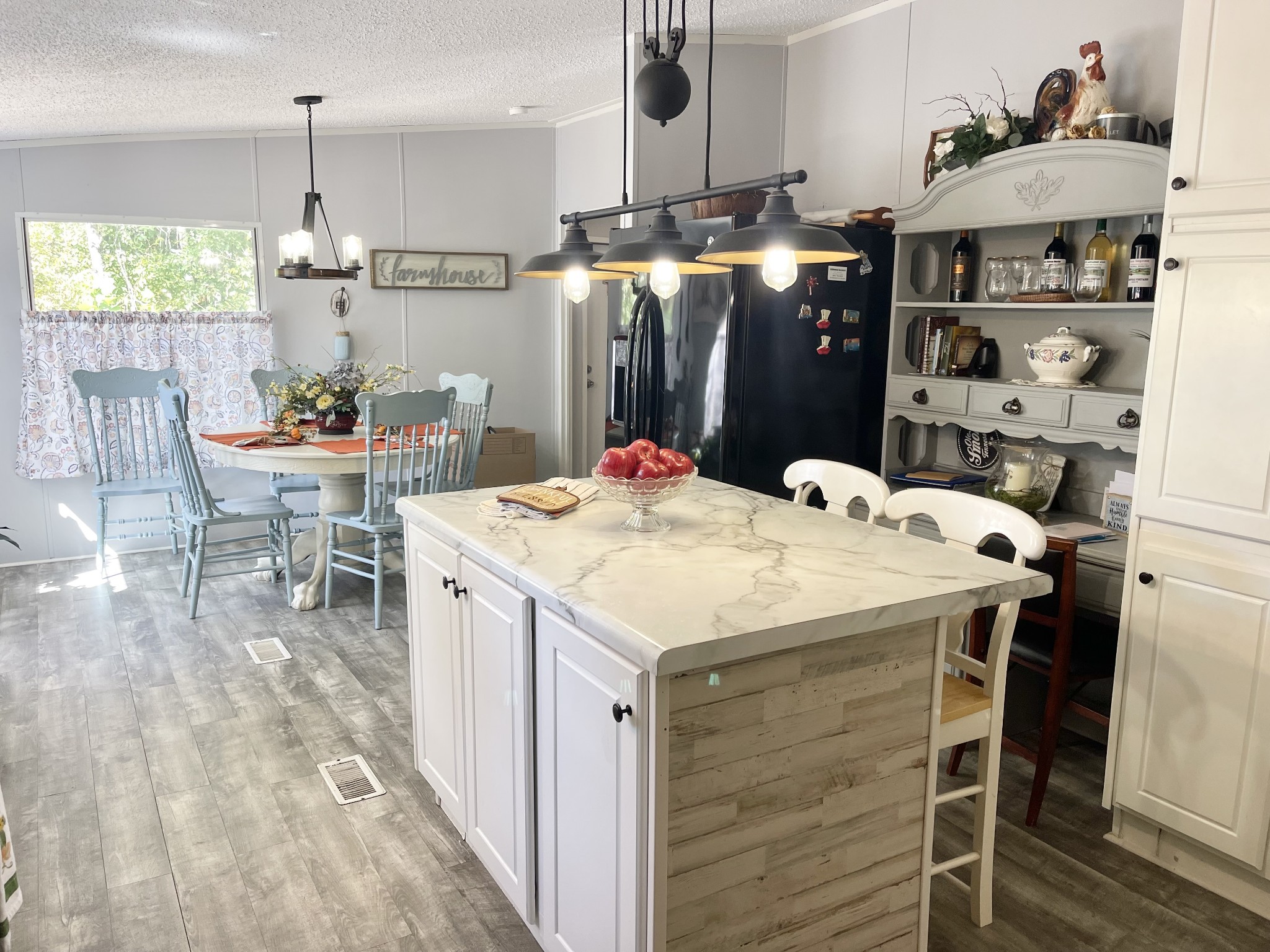 7593 Todd Road Westpoint, TN 38486 - Photo 5 of 41 a kitchen with stainless steel appliances kitchen island granite countertop a table chairs in it and wooden floors