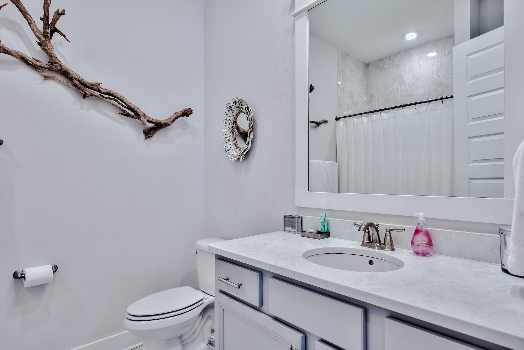 12 York Lane Inlet Beach, Unit A Inlet Beach, FL 32461 - Photo 19 of 59 a bathroom with a granite countertop sink a toilet and a mirror
