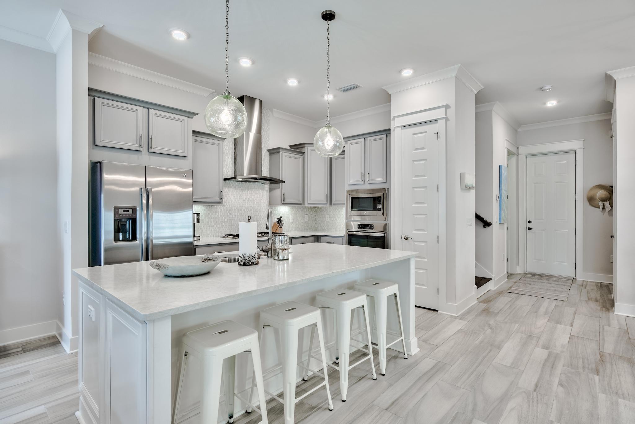12 York Lane Inlet Beach, Unit A Inlet Beach, FL 32461 - Photo 8 of 59 a kitchen with stainless steel appliances kitchen island granite countertop a sink refrigerator and cabinets
