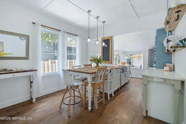 a kitchen that has a sink a stove and a table in it