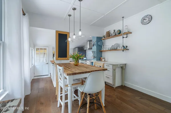 a kitchen with a table and chairs in it