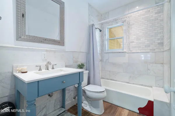 a view of a sitting area with large trees