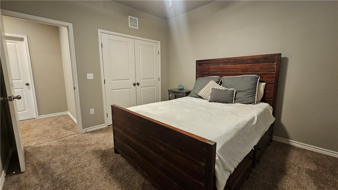 1051 Ocean Breeze Portland, TX 78374 - Photo 23 of 37 a bedroom with a bed and a mirror