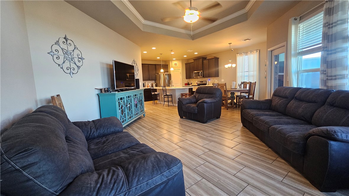 1051 Ocean Breeze Portland, TX 78374 - Photo 3 of 37 a living room with furniture kitchen view and a flat screen tv