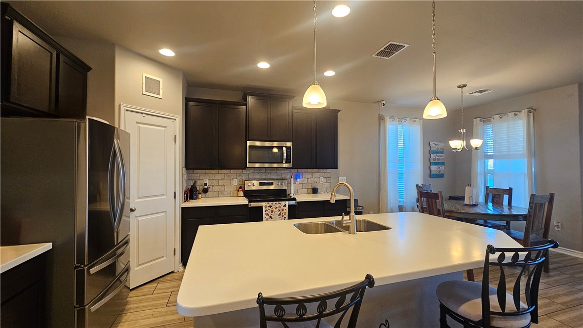 1051 Ocean Breeze Portland, TX 78374 - Photo 7 of 37 a large kitchen with a table and chairs
