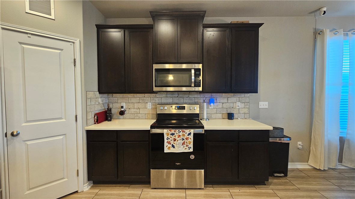 1051 Ocean Breeze Portland, TX 78374 - Photo 8 of 37 a kitchen with stainless steel appliances a stove and a microwave