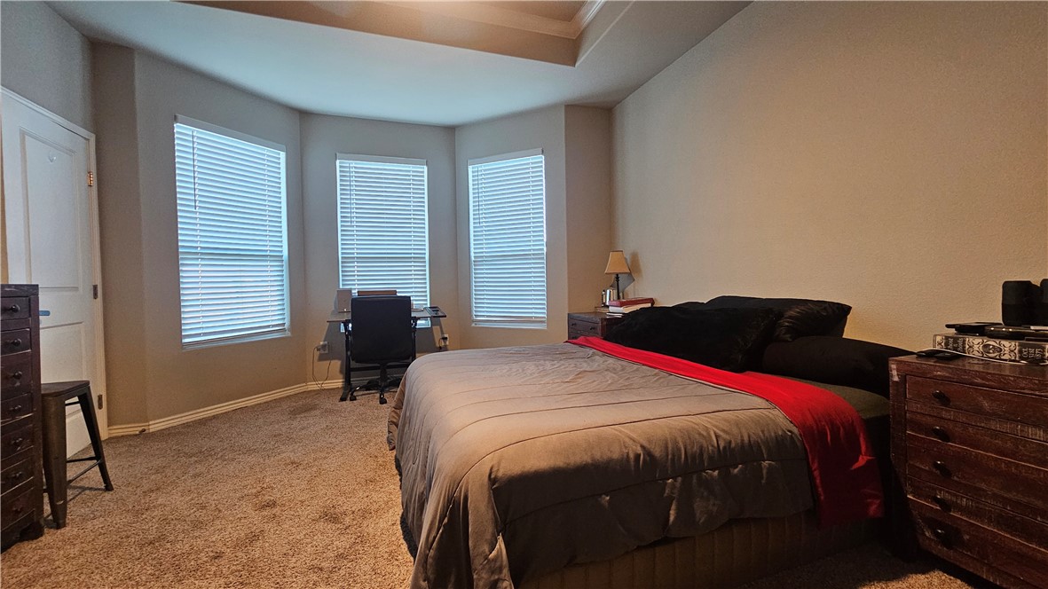 1051 Ocean Breeze Portland, TX 78374 - Photo 9 of 37 a bedroom with a bed and wooden floor