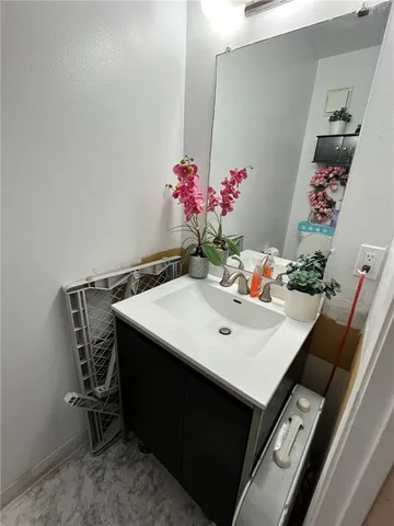 a view of a room with furniture and flowers