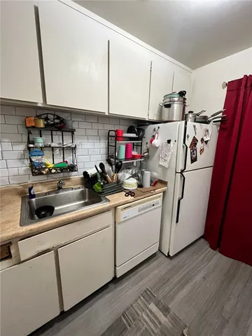 a kitchen with refrigerator and cabinets
