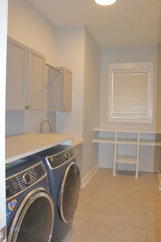 a view of a storage & utility room with a washer dryer