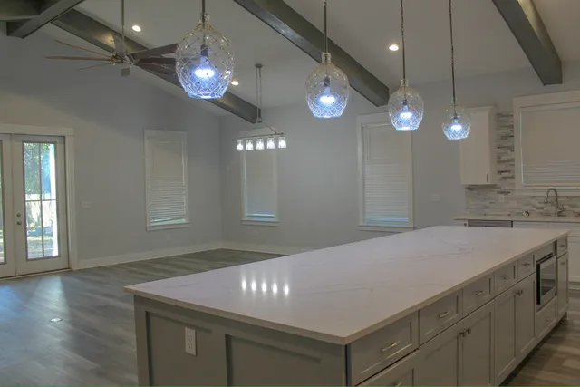 a kitchen with a sink a microwave a stove and refrigerator