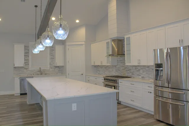 a kitchen with a sink a refrigerator and a stove