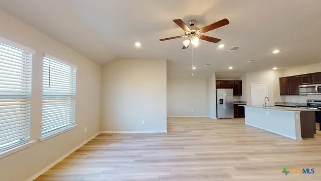 a view of a kitchen with a sink and a window