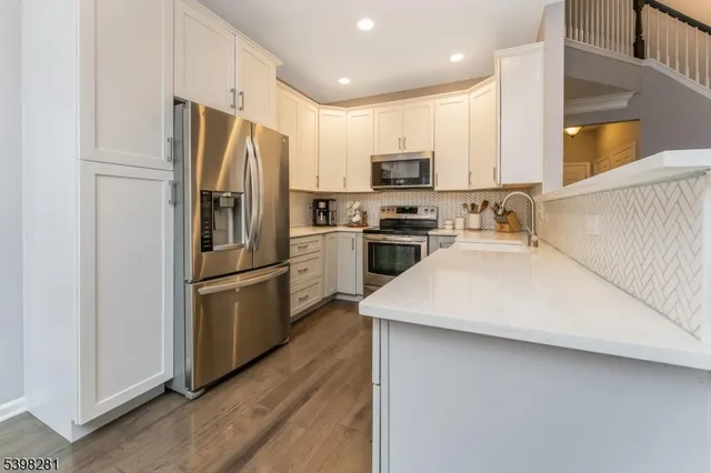 a kitchen with stainless steel appliances a refrigerator stove microwave and sink