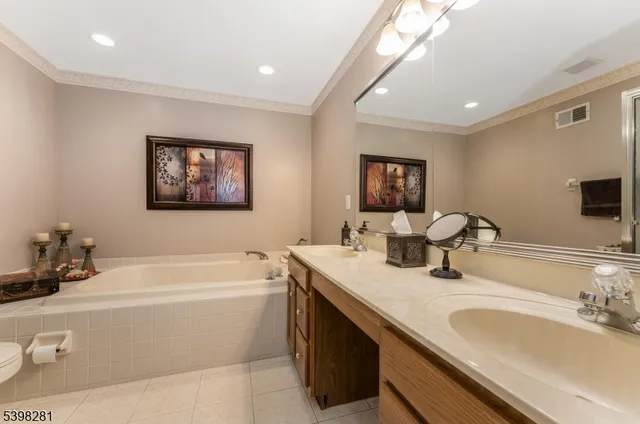 a spacious bedroom with a bed lamp and a window