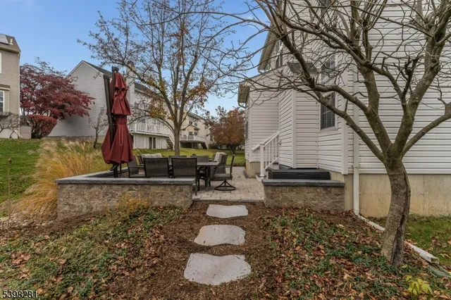 a view of a patio with a table and chairs and a fire pit