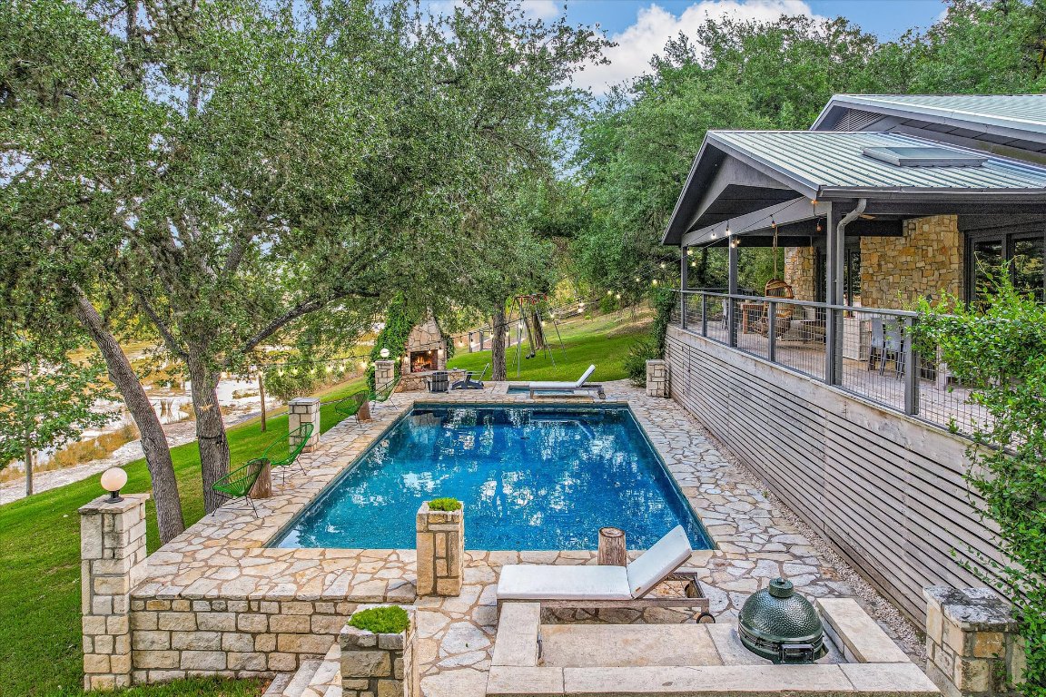 a view of house with swimming pool outdoor seating