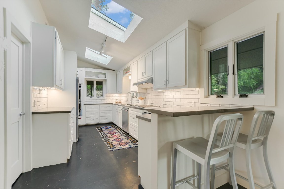 1121 Hidden Valley Road Wimberley, TX 78676 - Photo 15 of 40 a kitchen with cabinets and window