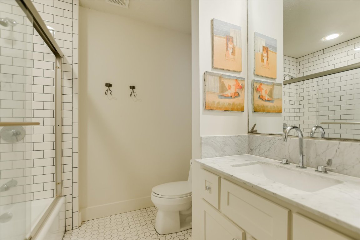 1121 Hidden Valley Road Wimberley, TX 78676 - Photo 22 of 40 a bathroom with a granite countertop sink toilet and shower