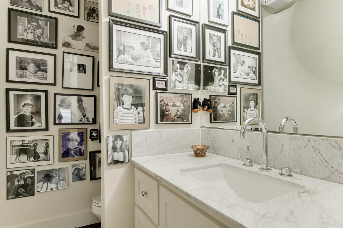 1121 Hidden Valley Road Wimberley, TX 78676 - Photo 23 of 40 a bathroom with a granite countertop sink and a large mirror