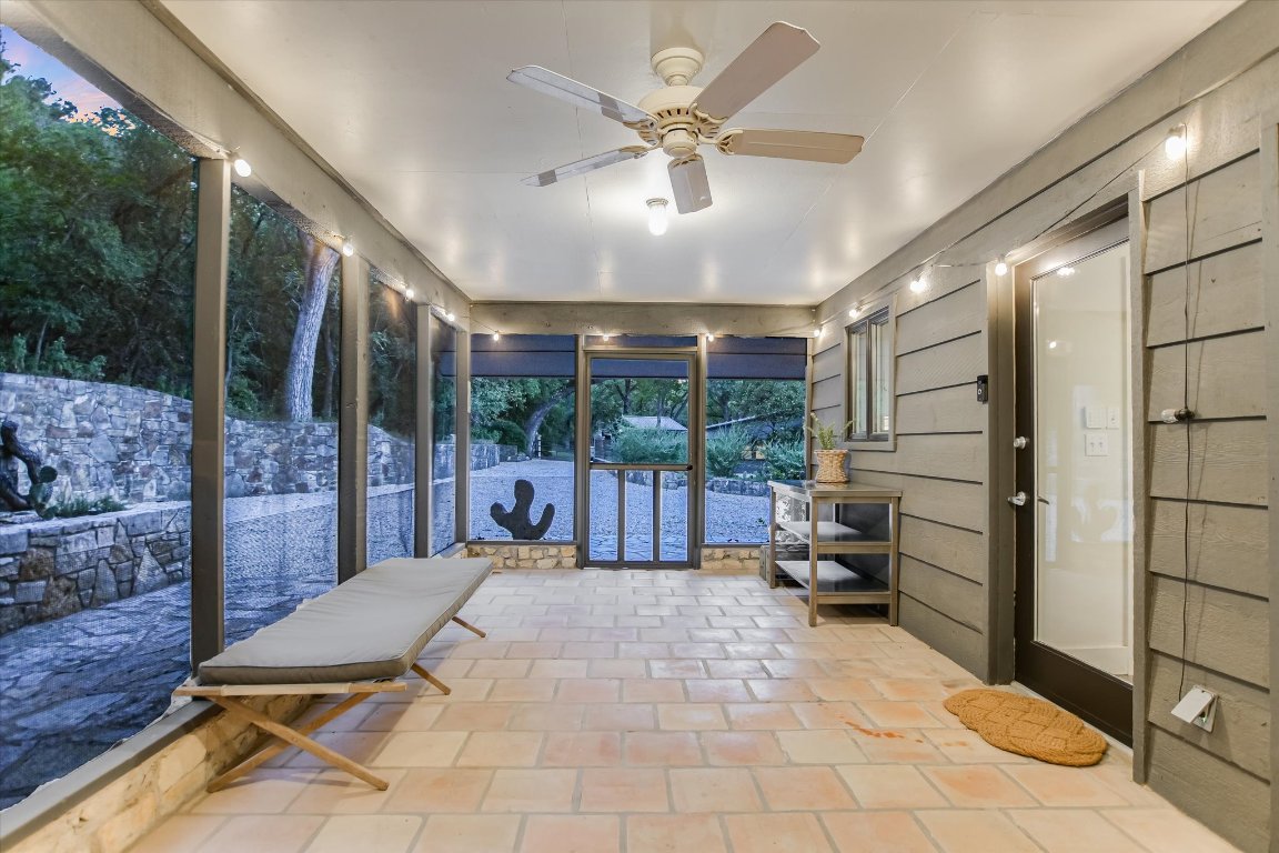 1121 Hidden Valley Road Wimberley, TX 78676 - Photo 24 of 40 a room with lots of furniture and a chandelier