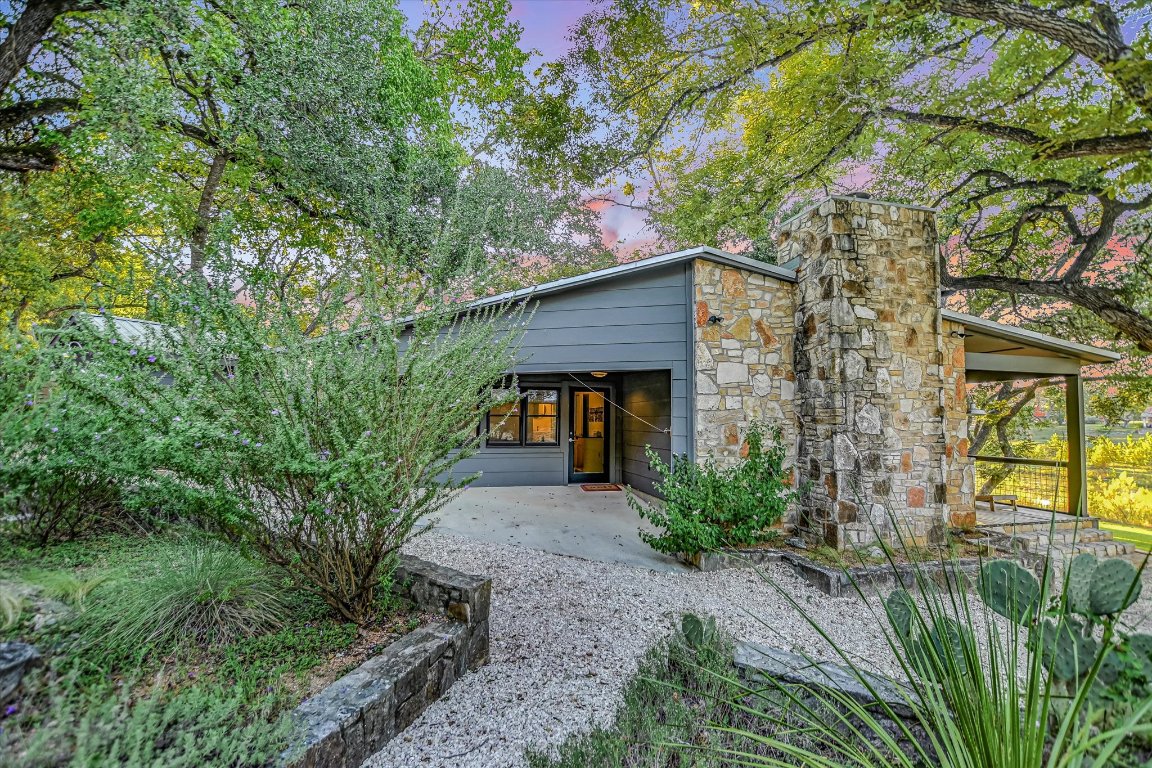 1121 Hidden Valley Road Wimberley, TX 78676 - Photo 29 of 40 a front view of a house with garden