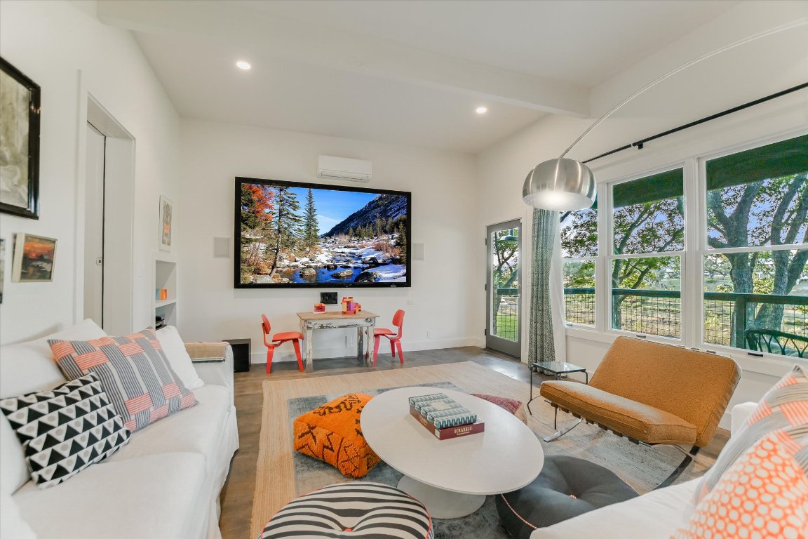 1121 Hidden Valley Road Wimberley, TX 78676 - Photo 33 of 40 a living room with furniture and a flat screen tv