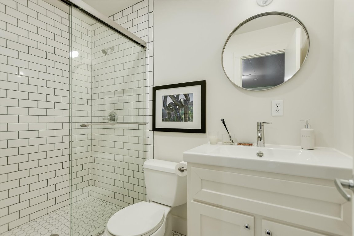 1121 Hidden Valley Road Wimberley, TX 78676 - Photo 37 of 40 a bathroom with a toilet sink and mirror