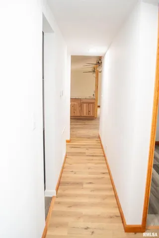 a view of a room with wooden floor and bathroom