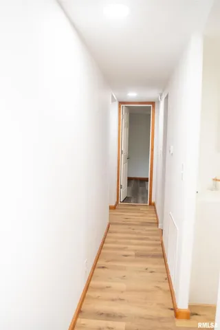 a view of a closet with wooden floor