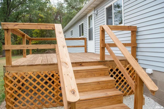 a view of outdoor space with deck and white cabinets