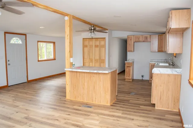 a view of a kitchen with furniture and wooden floor