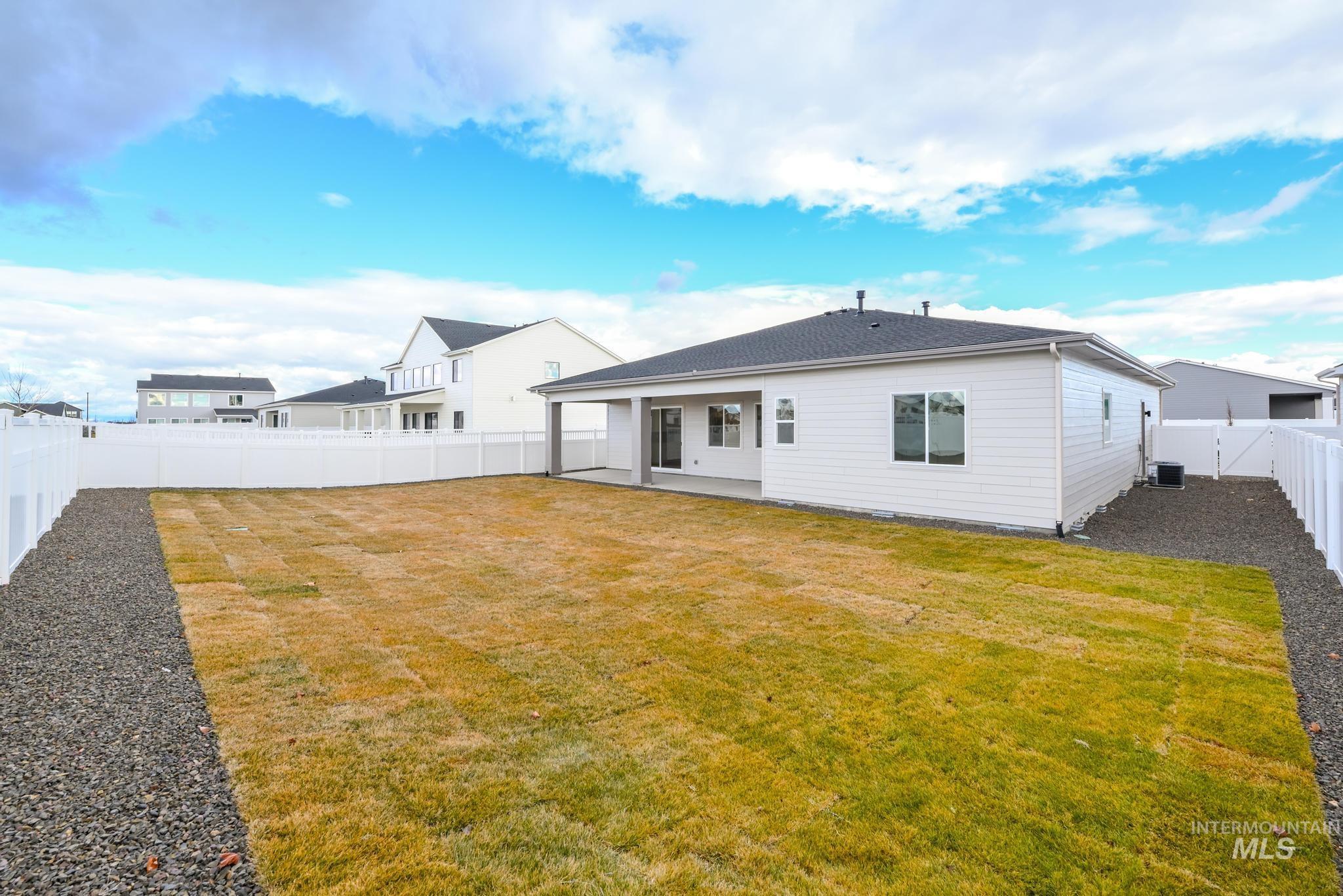 8501 South Country Wind Avenue Meridian, ID 83642 - Photo 29 of 39 Back of property with a patio and a fenced backyard