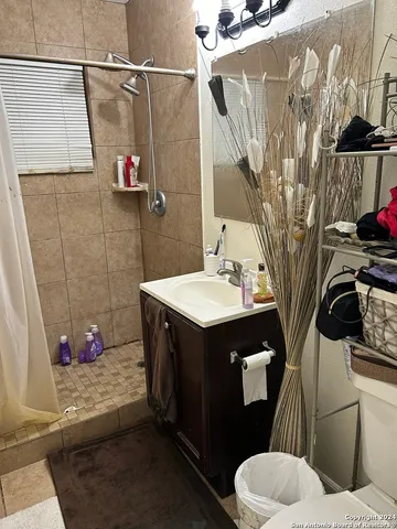a bathroom with a sink toilet and shower